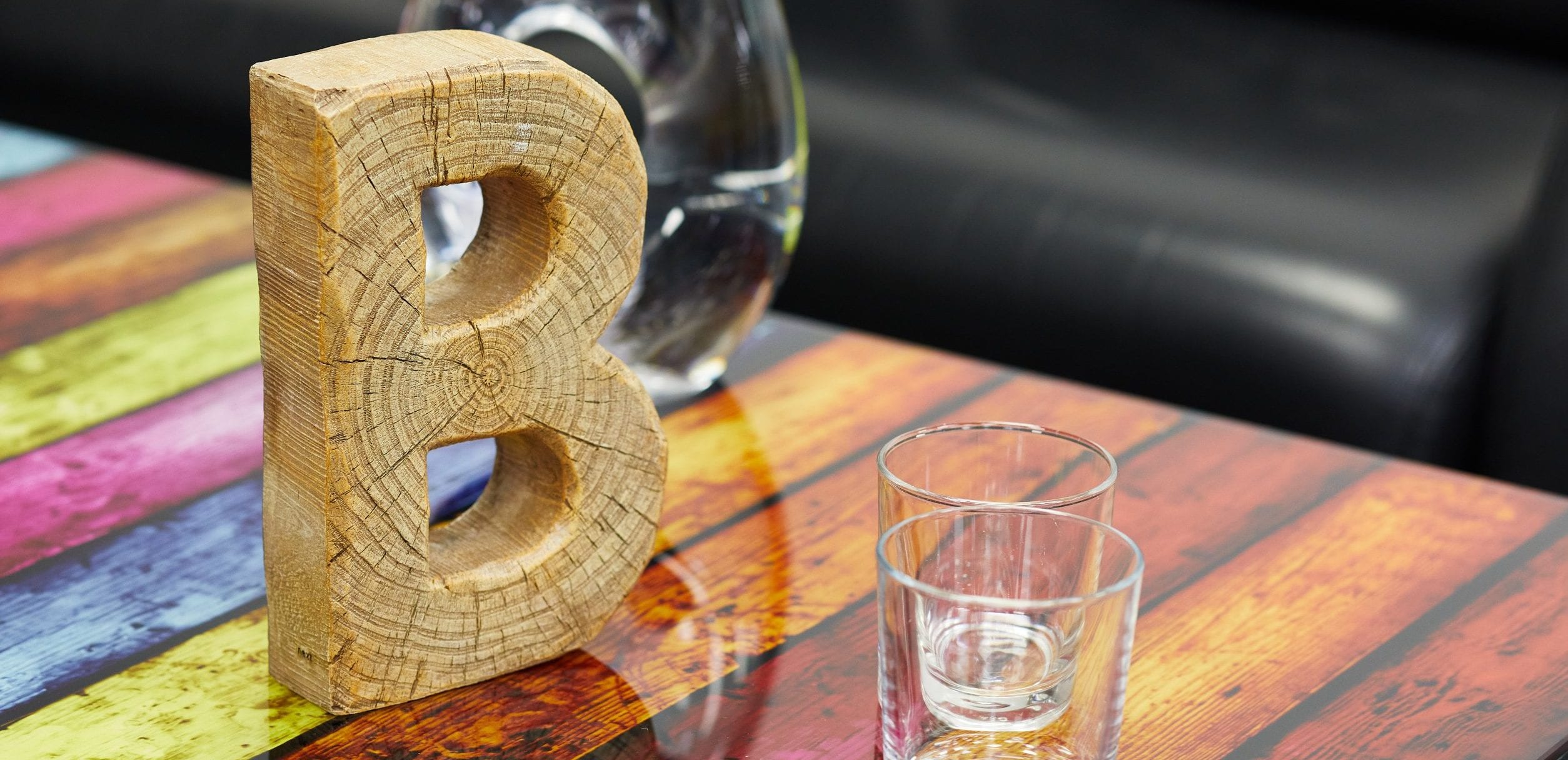Wooden B on table
